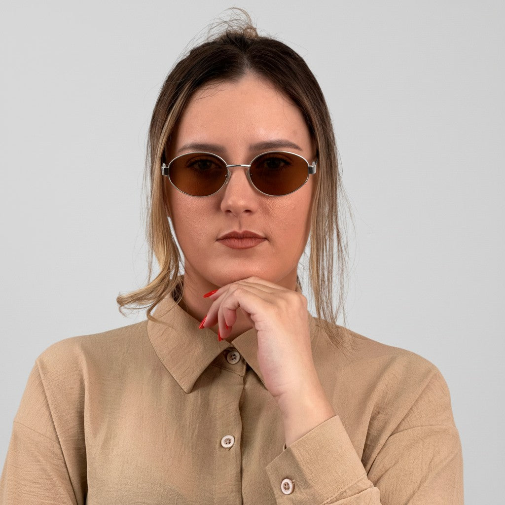 Euglasses Artemis oval sunglasses with silver metal frames and brown lenses, featuring a diamond-shaped detail on the temples.